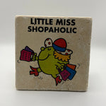 Little Miss Shopaholic illustration printed on square travertine stone coaster