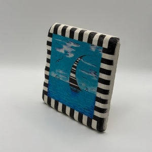 Sailboat artwork printed on square travertine stone coaster