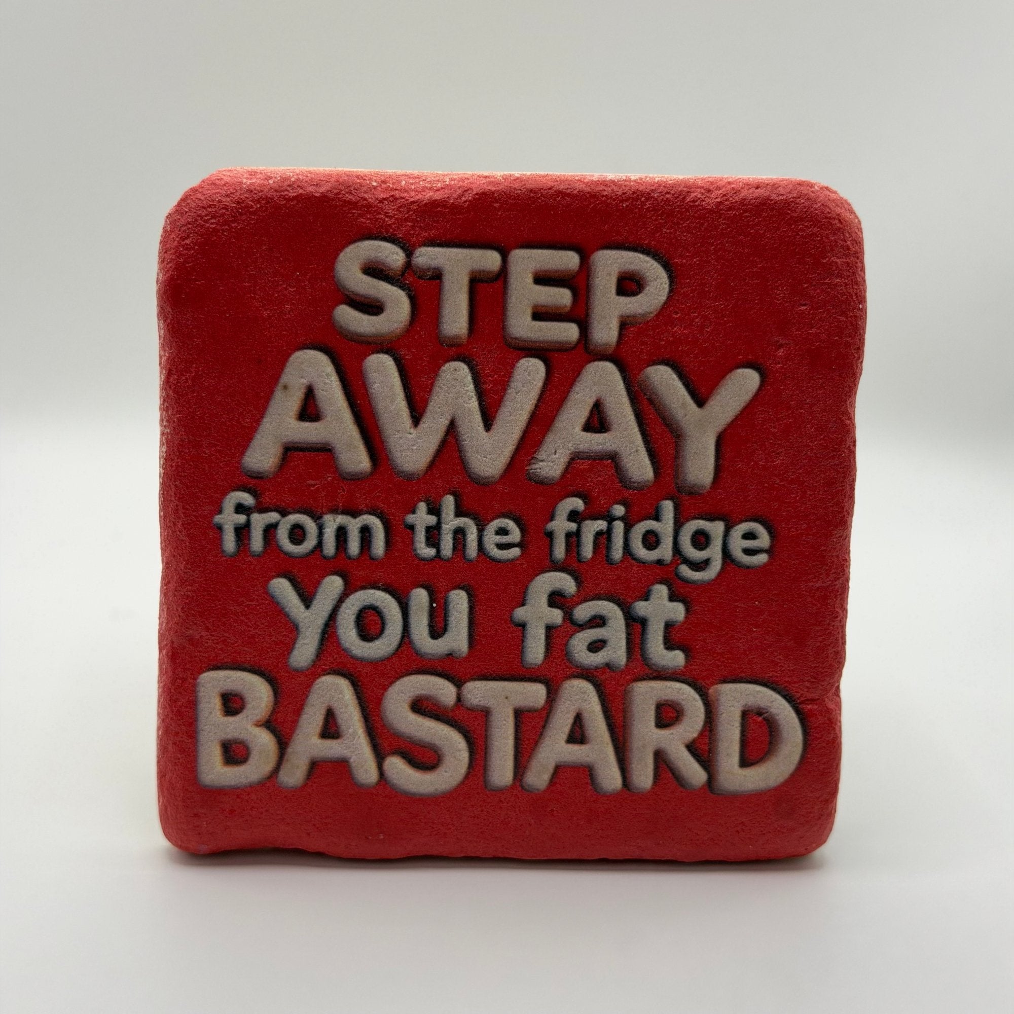Funny slogan 'Step Away from the Fridge, You Fat Bastard' printed on square travertine stone coaster