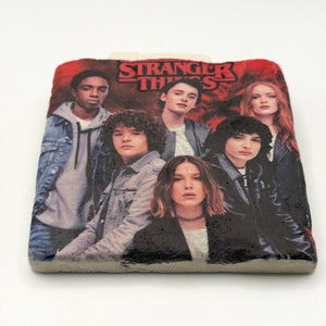 Stranger Things logo or character artwork printed on square travertine stone coaster