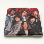 Stranger Things logo or character artwork printed on square travertine stone coaster
