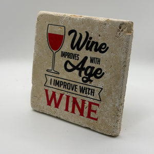 Wine improves with age quote printed on square natural travertine stone coaster