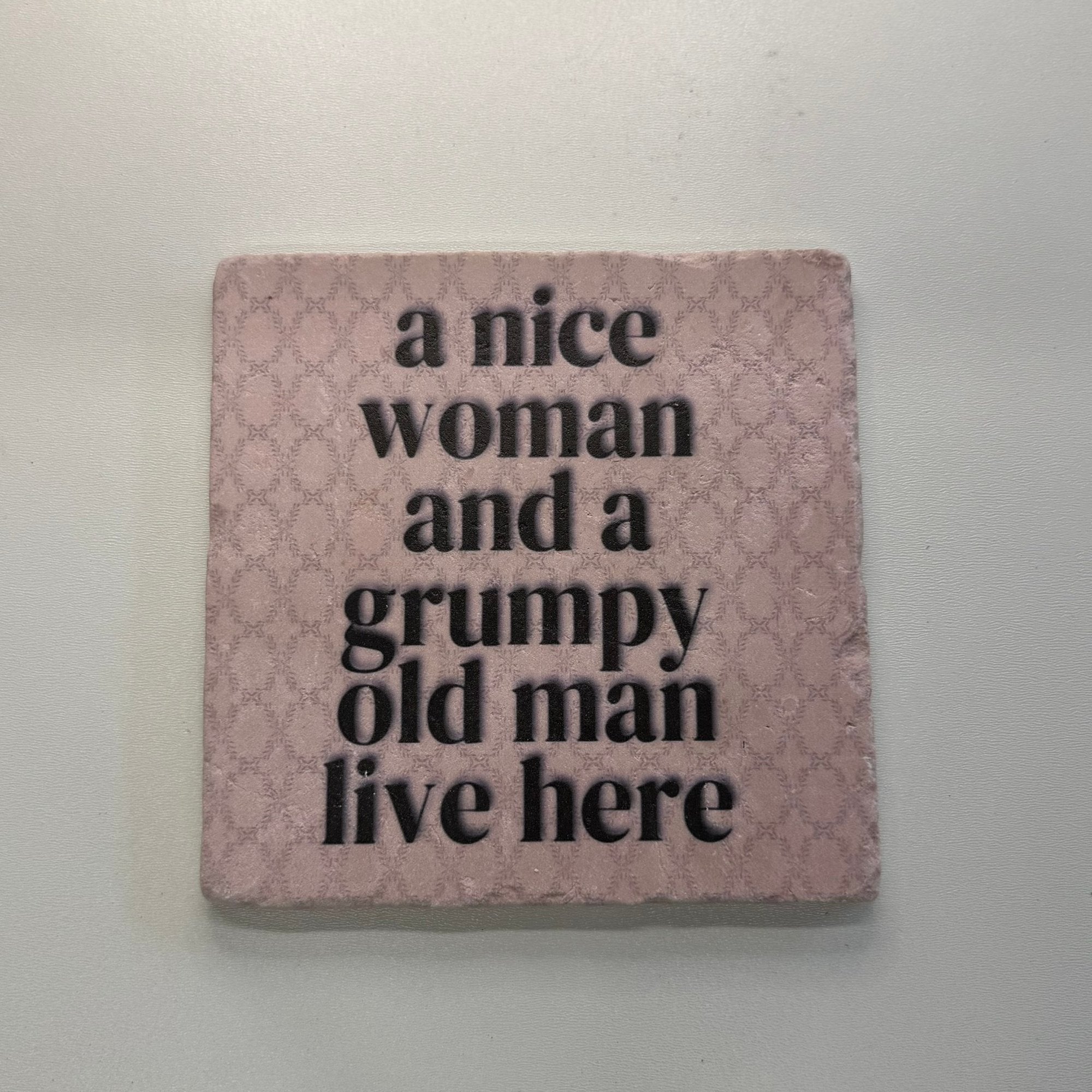 A Nice Woman And A Grumpy Old Man Live Here Natural Travertine Stone Hotpad artwork
