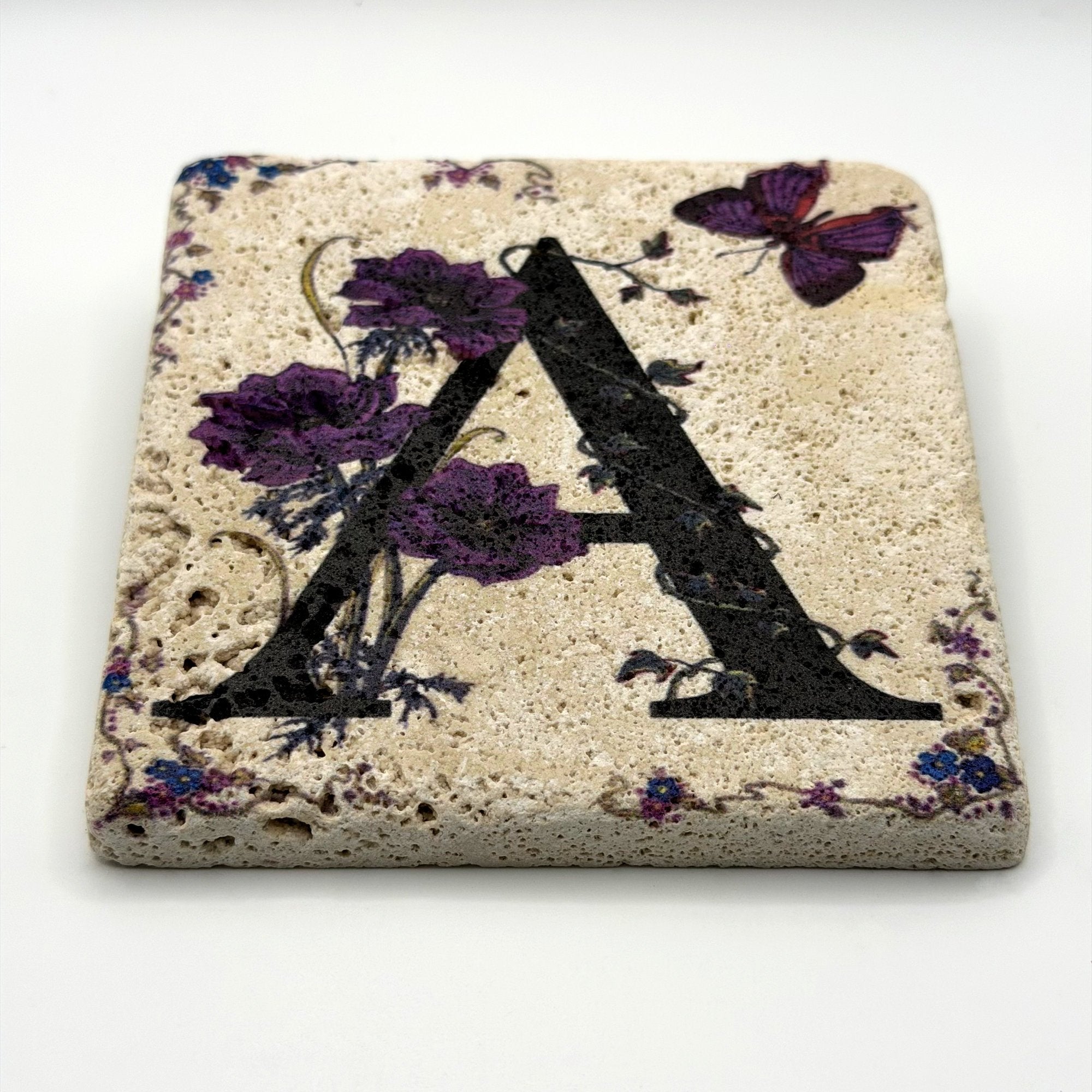 Alphabet letter A design printed on a natural stone coaster