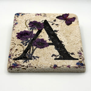 Alphabet letter A design printed on a natural stone coaster