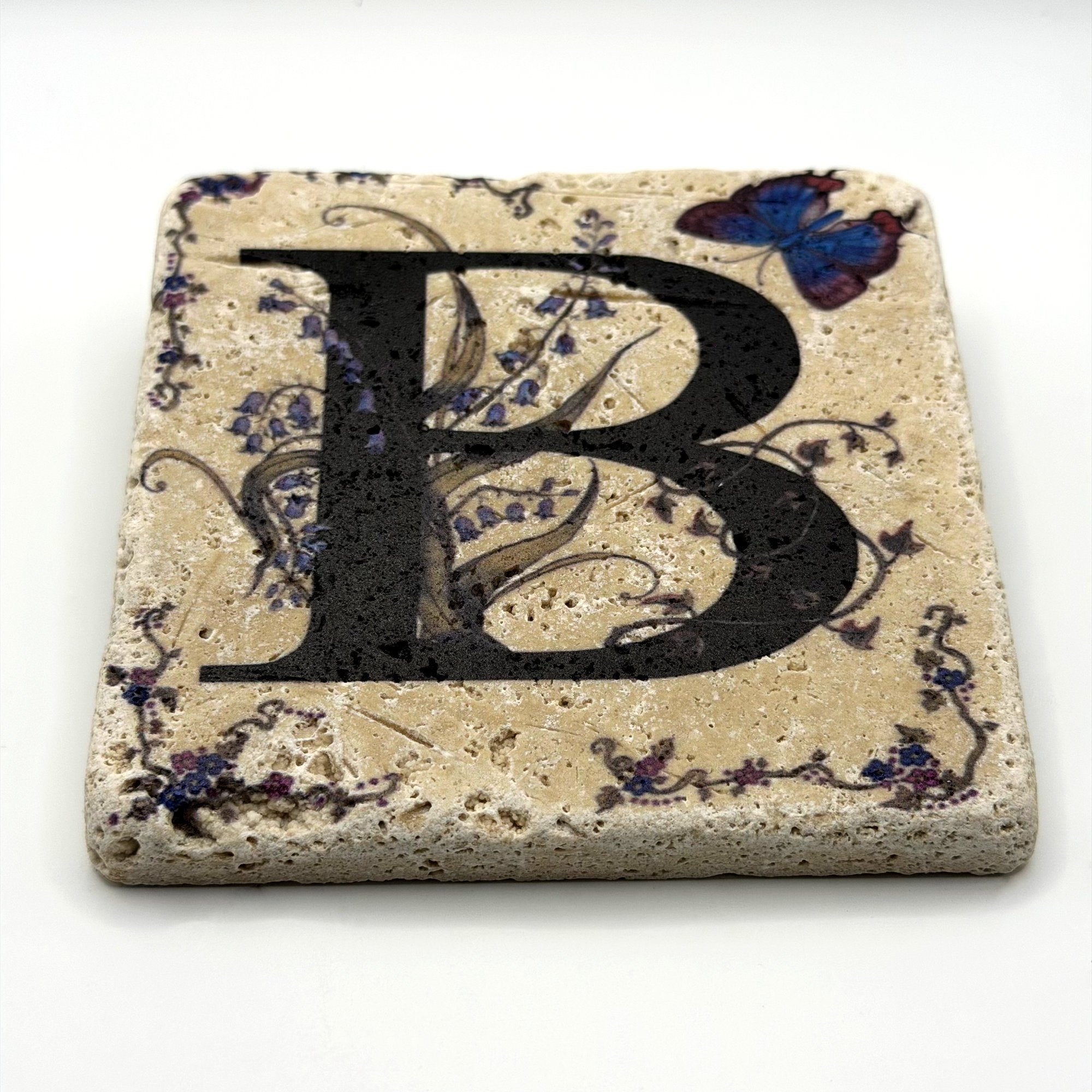 Alphabet letter B design printed on a natural stone coaster