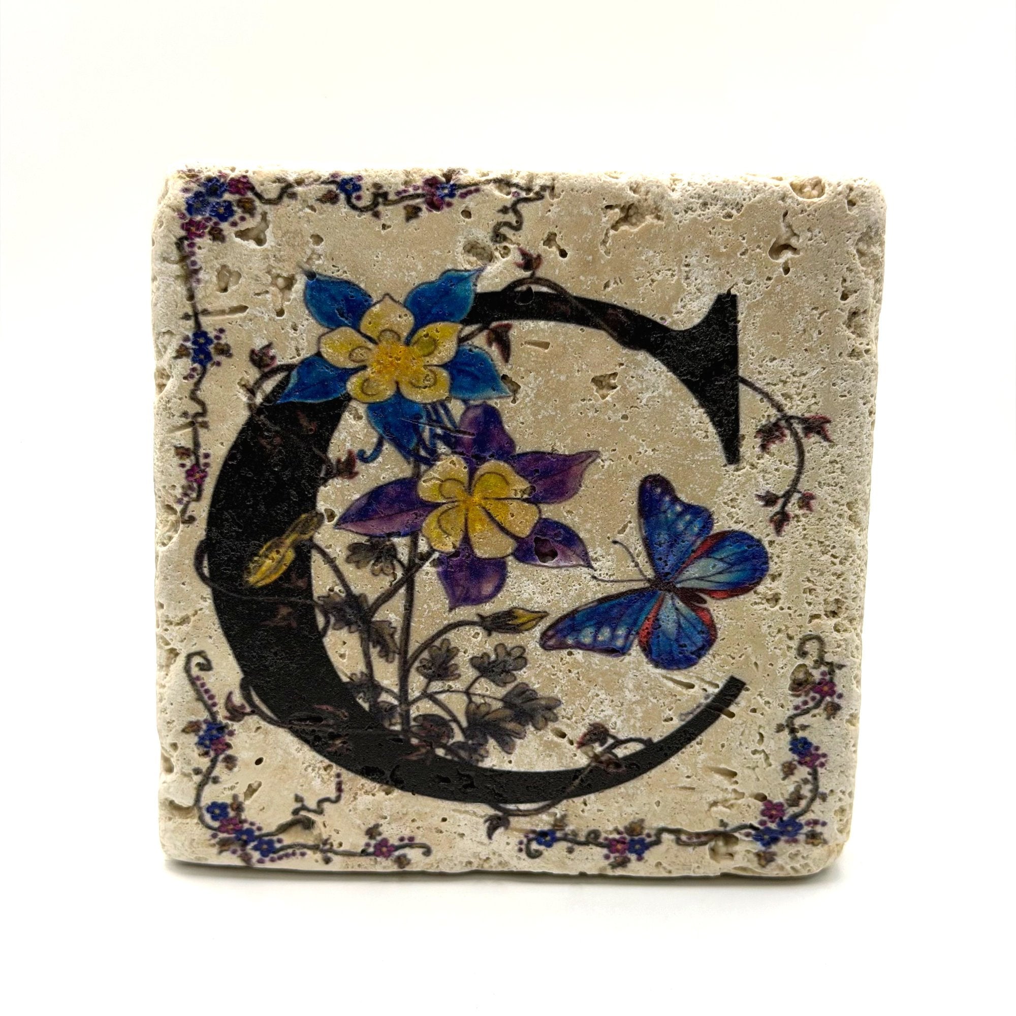 Alphabet letter C design printed on a natural stone coaster