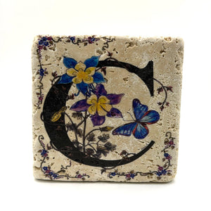 Alphabet letter C design printed on a natural stone coaster
