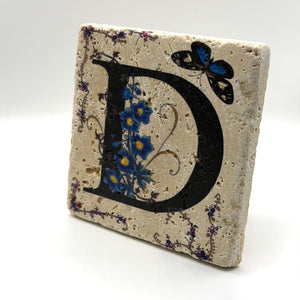 Alphabet letter D design printed on a natural stone coaster