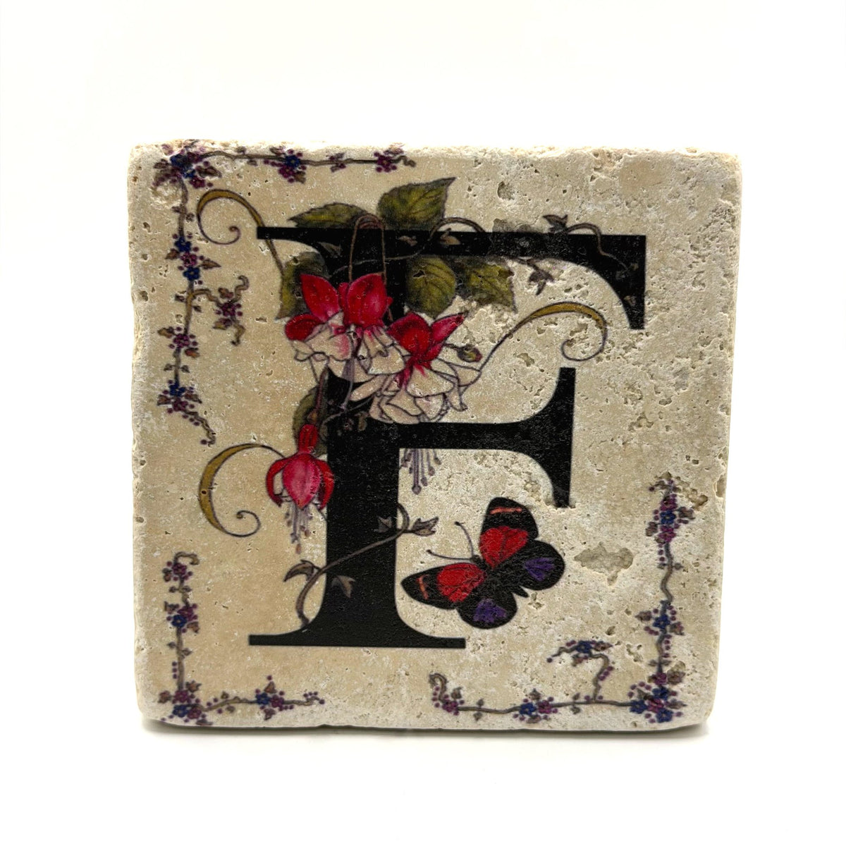 Alphabet letter F design printed on a natural stone coaster