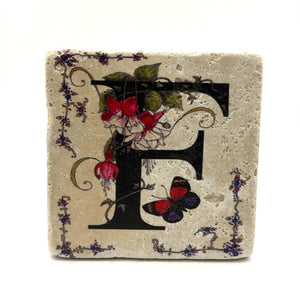 Alphabet letter F design printed on a natural stone coaster
