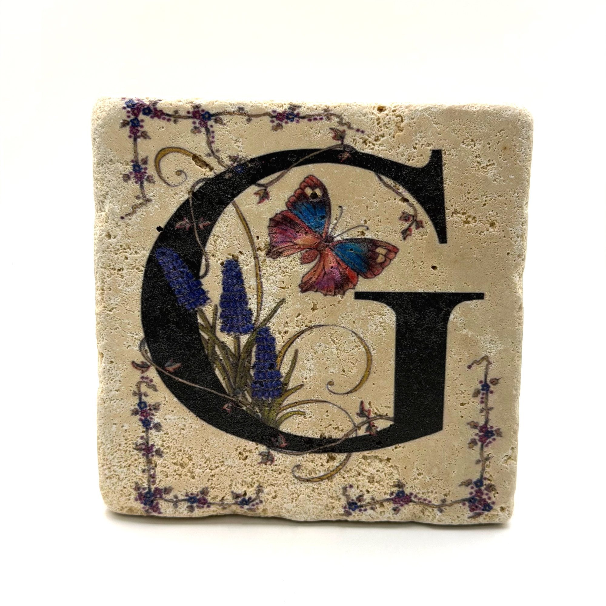 Alphabet letter G design printed on a natural stone coaster