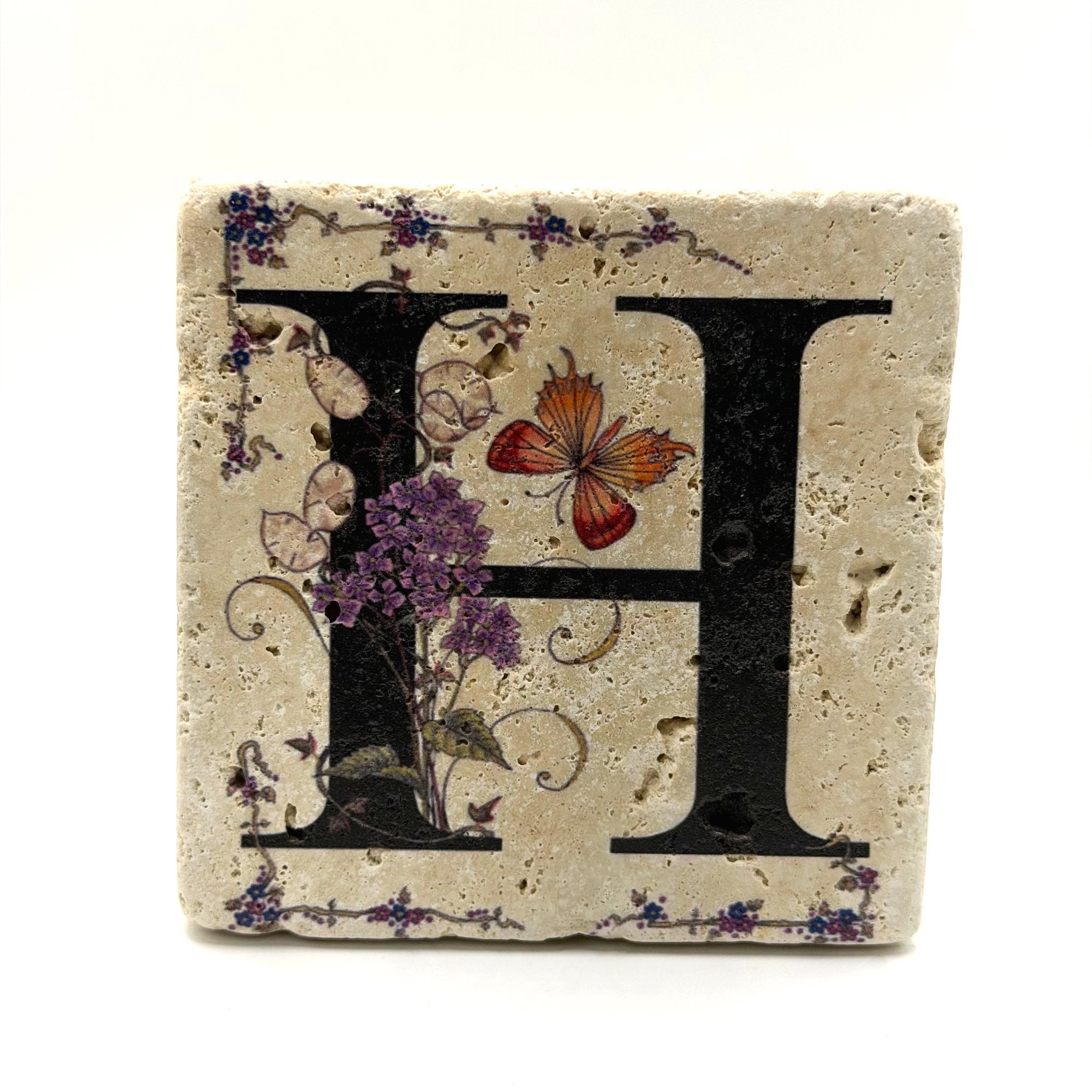 Alphabet letter H design printed on a natural stone coaster