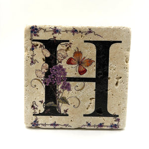 Alphabet letter H design printed on a natural stone coaster