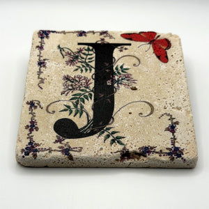 Alphabet letter J design printed on a natural stone coaster