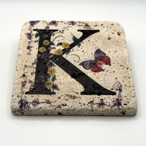 Alphabet letter K design printed on a natural stone coaster