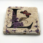 Alphabet letter L design printed on a natural stone coaster