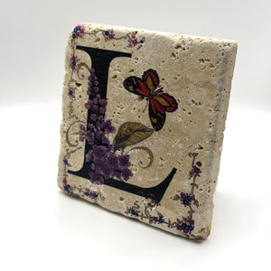 Alphabet letter L design printed on a natural stone coaster