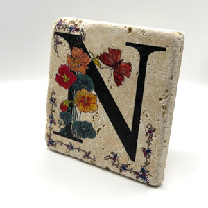 Alphabet letter N design printed on a natural stone coaster