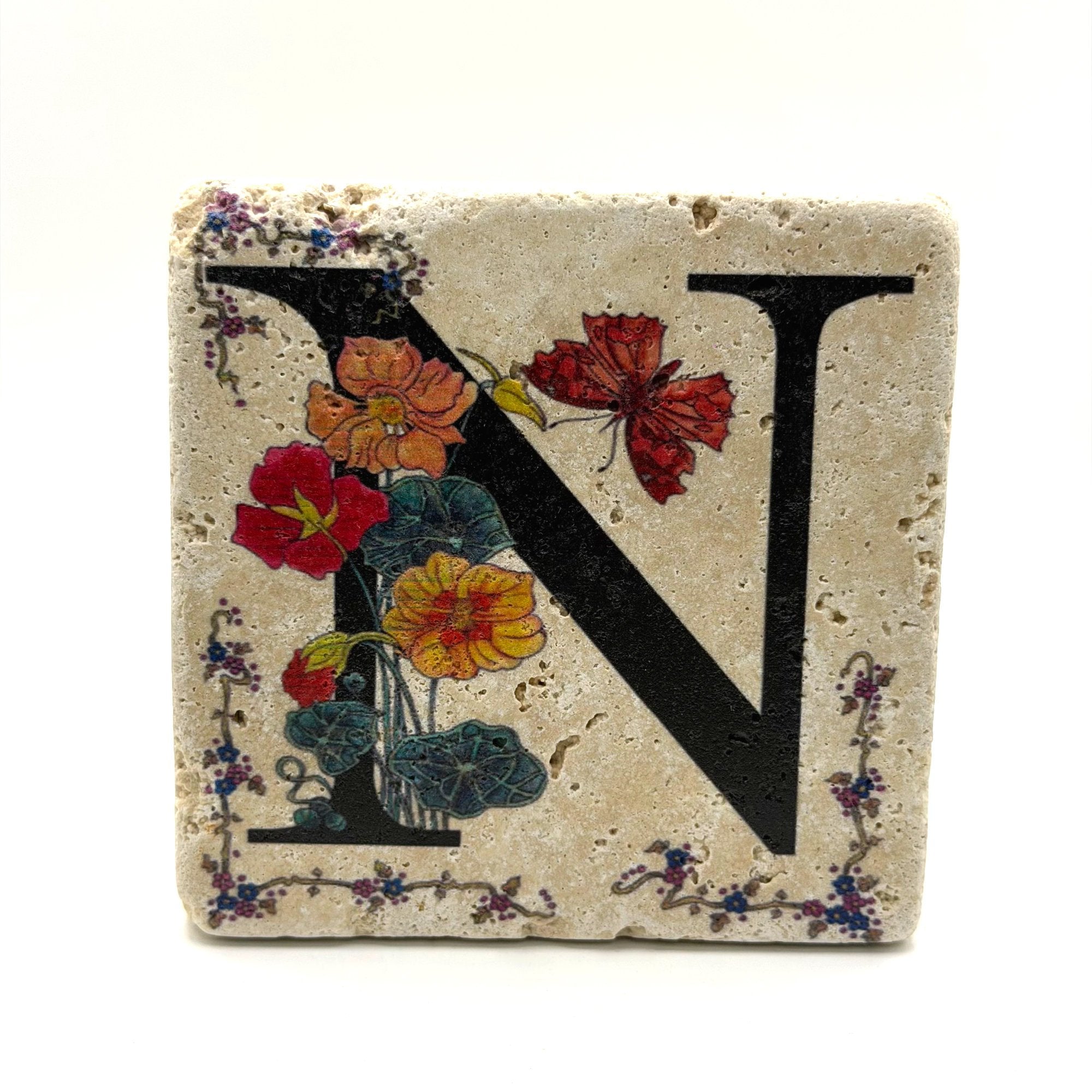 Alphabet letter N design printed on a natural stone coaster