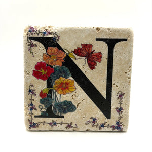 Alphabet letter N design printed on a natural stone coaster