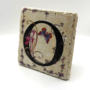 Alphabet letter O design printed on a natural stone coaster