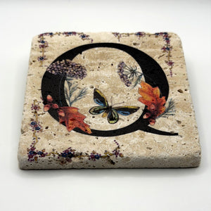 Alphabet letter Q design printed on a natural stone coaster