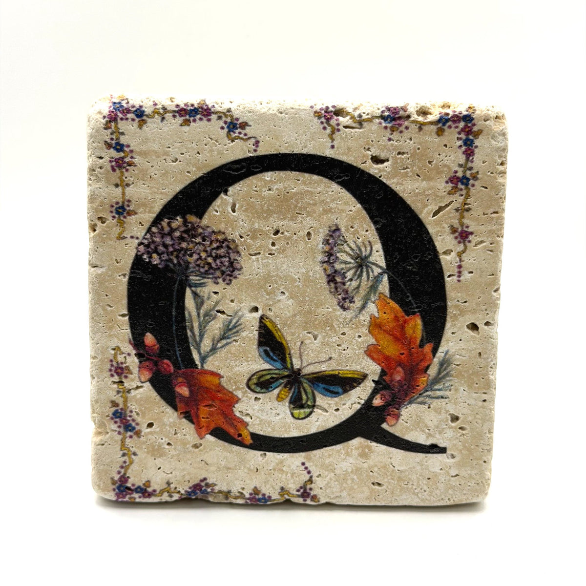 Alphabet letter Q design printed on a natural stone coaster