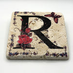 Alphabet letter R design printed on a natural stone coaster