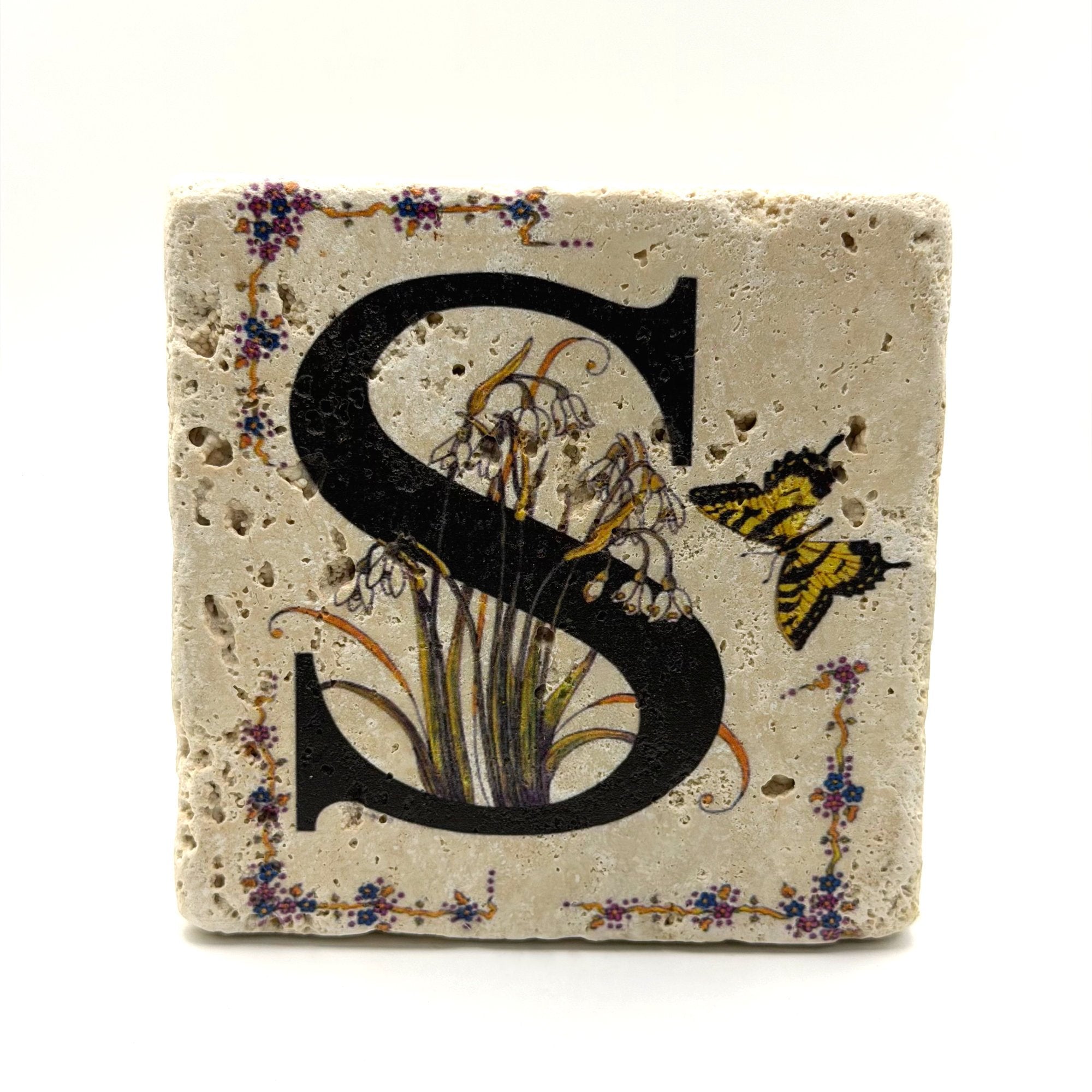 Alphabet letter S design printed on a natural stone coaster
