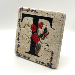 Alphabet letter T design printed on a natural stone coaster