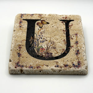 Alphabet letter U design printed on a natural stone coaster