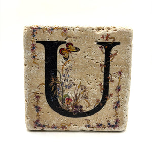 Alphabet letter U design printed on a natural stone coaster