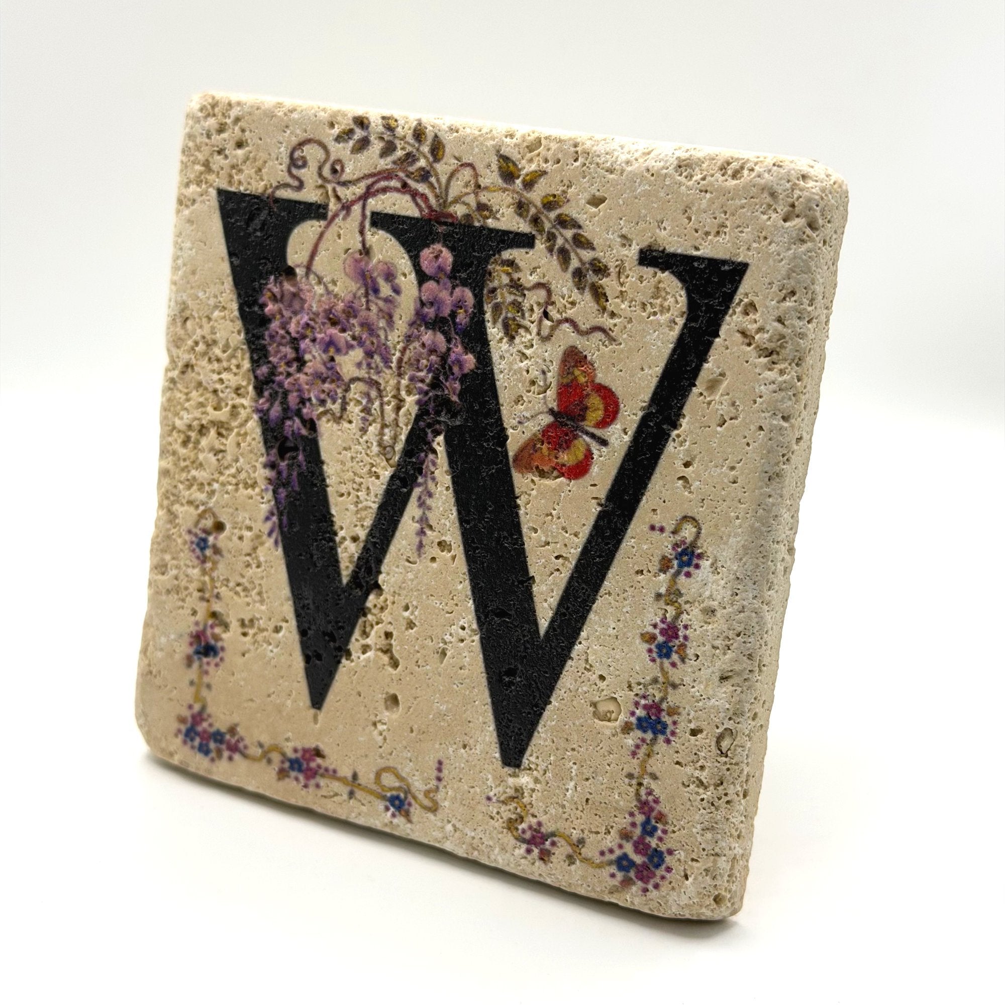 Alphabet letter W design printed on a natural stone coaster