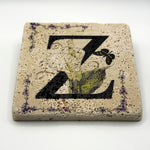 Alphabet letter Z design printed on a natural stone coaster