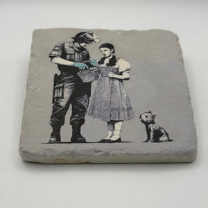 Banksy's artwork depicting Dorothy Police Search printed on square travertine stone coaster