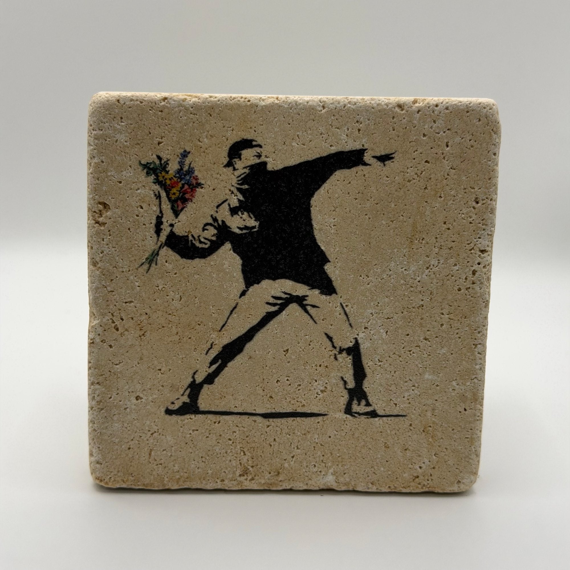 Banksy's iconic 'Flower Thrower' artwork printed on square travertine stone coaster