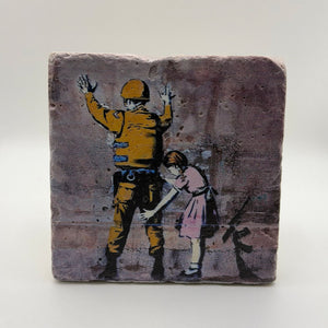Banksy-style artwork printed on square travertine stone coaster