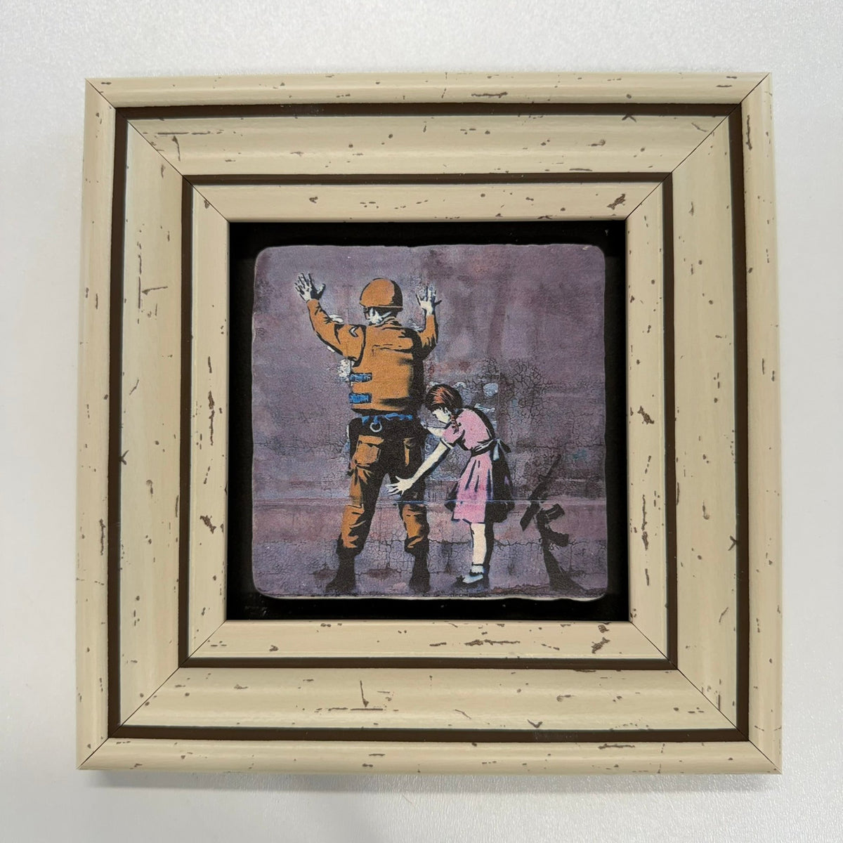 Variant Mapping v4 | banksy-girl-frisking-soldier-natural-stone-coaster | with White Frame | sha256:45f28a64e0a2