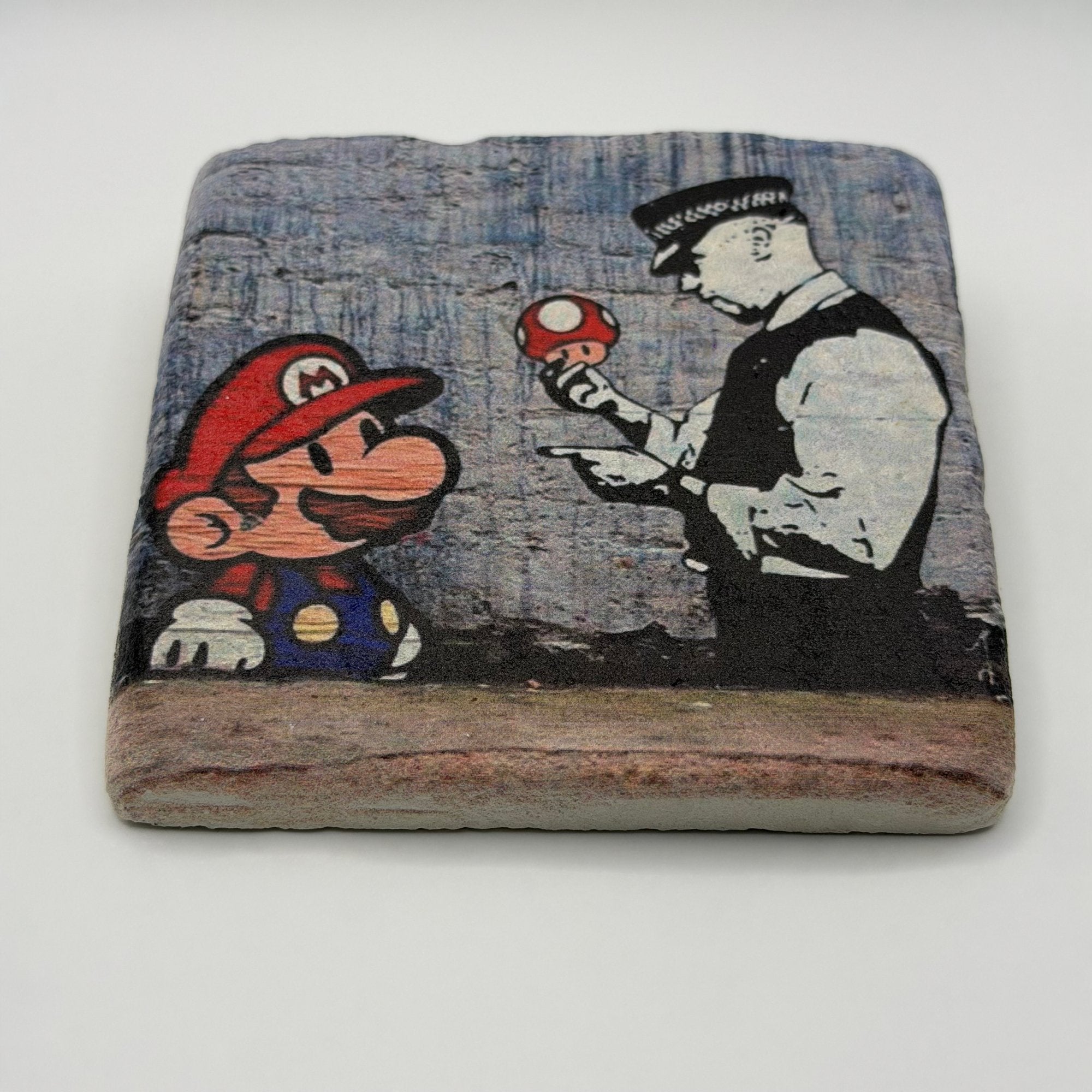 Banksy artwork featuring Mario and Cop printed on square travertine stone coaster