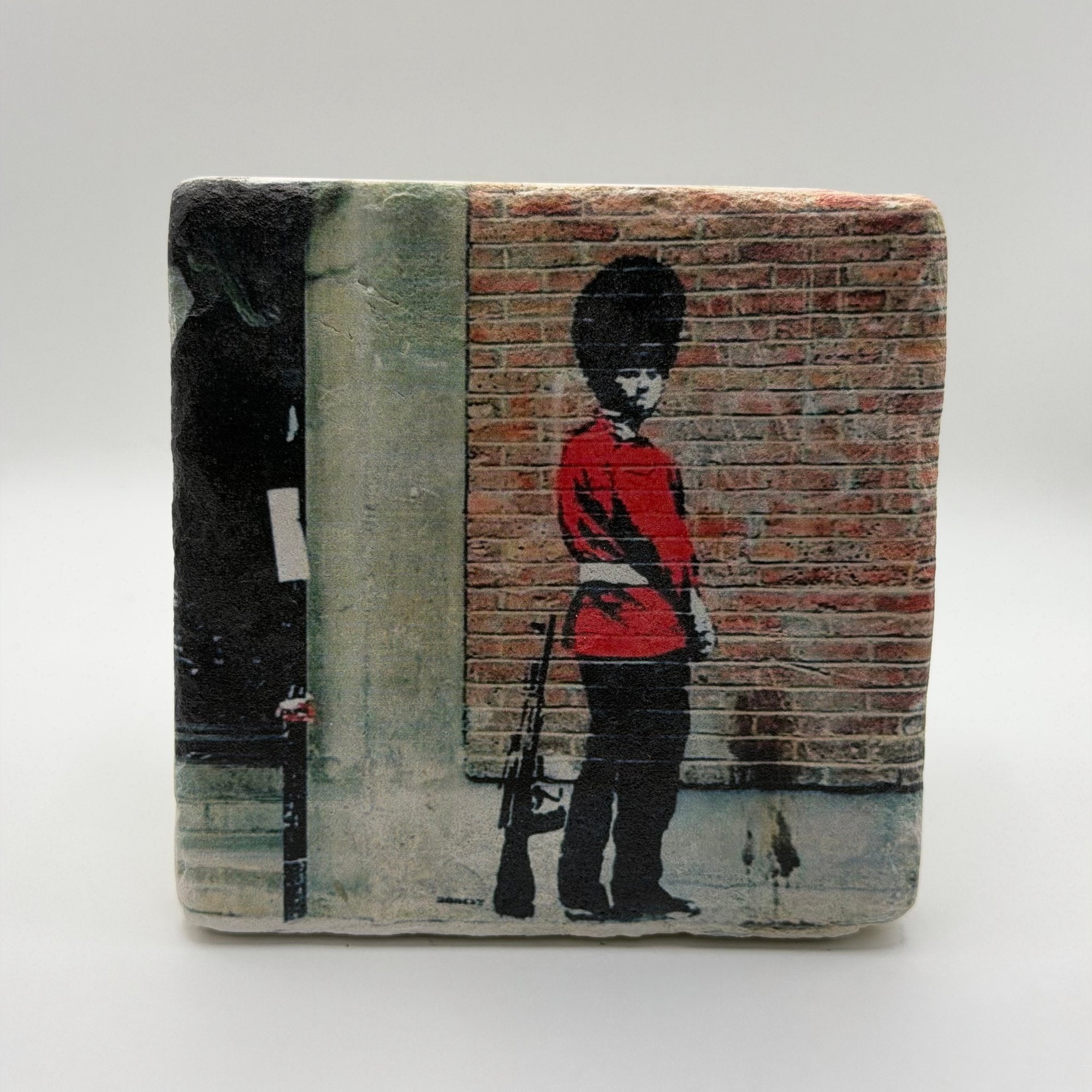 Banksy Pissing Guard artwork printed on square travertine stone coaster