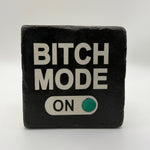 Funny quote 'Bitch Mode On' printed on square travertine stone coaster
