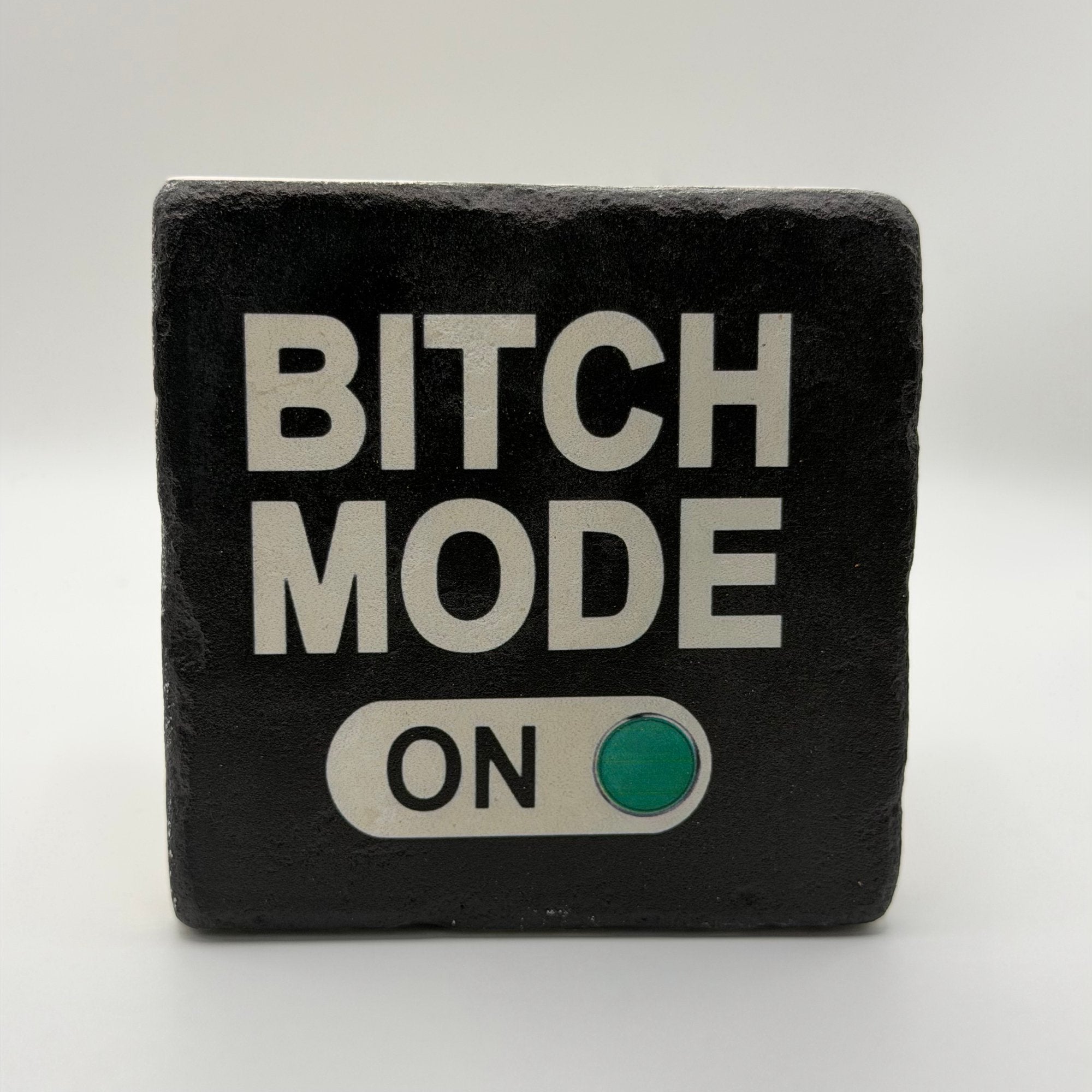 Funny quote 'Bitch Mode On' printed on square travertine stone coaster