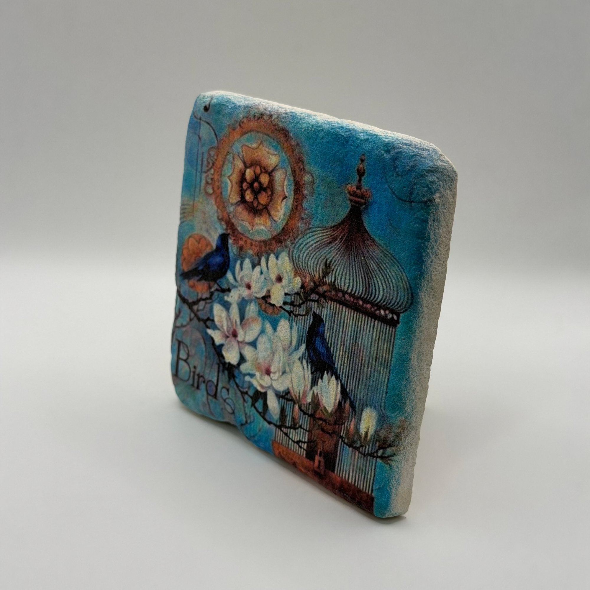 Colorful blue bird artwork printed on square travertine stone coaster