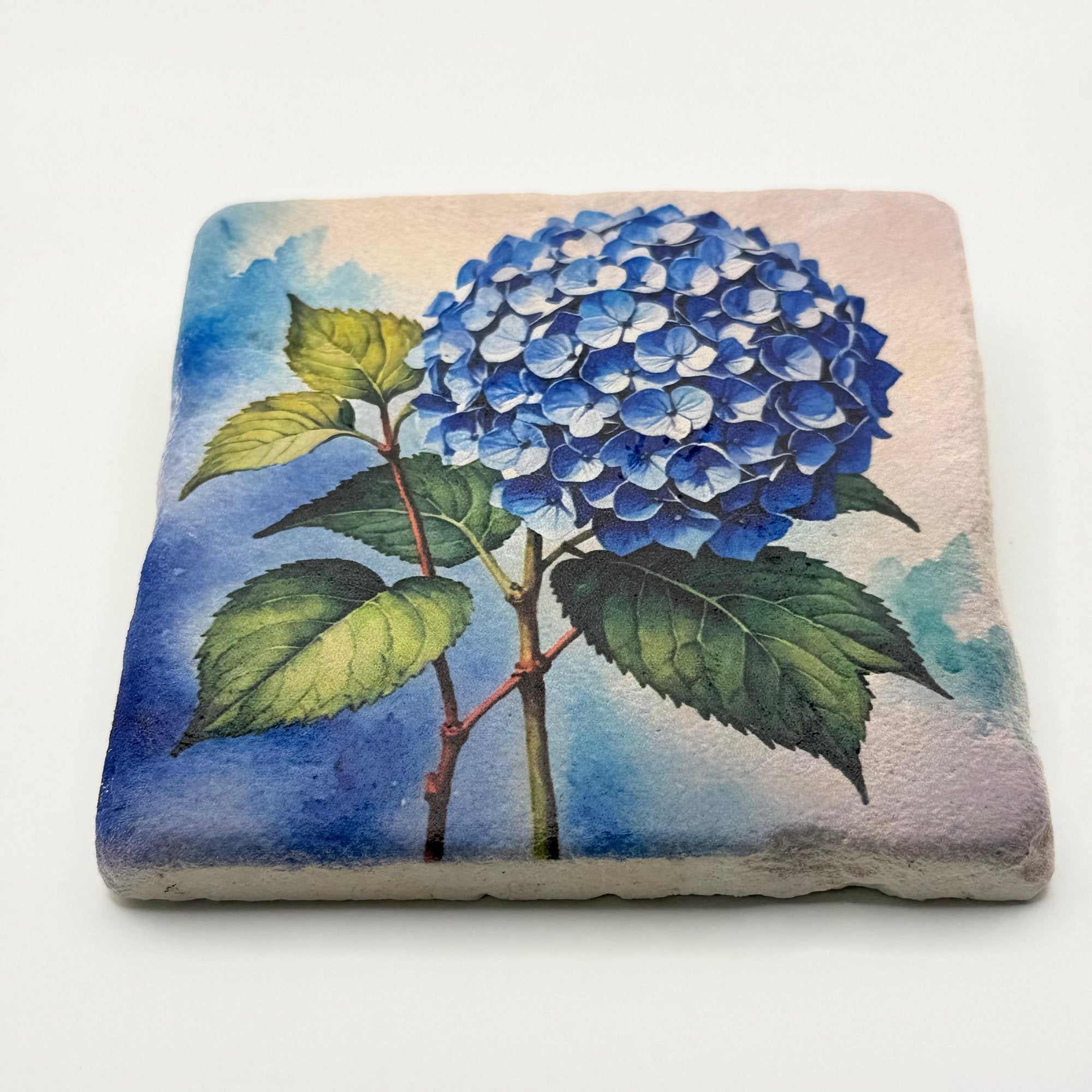 Vintage blue hydrangea artwork printed on square travertine stone coaster