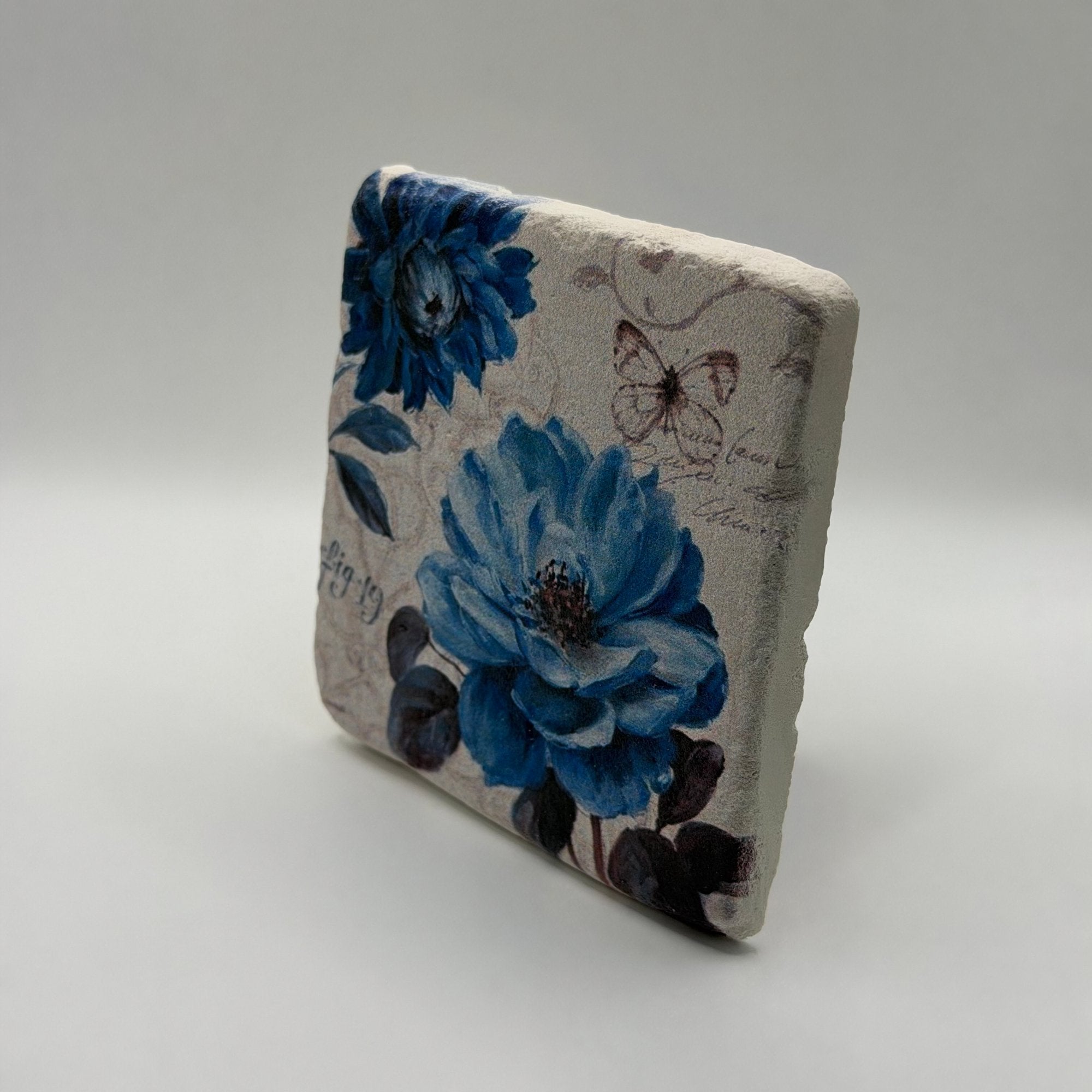 Vintage blue botanical artwork printed on square travertine stone coaster