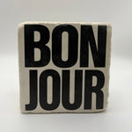 French phrase 'Bonjour' printed on square travertine stone coaster