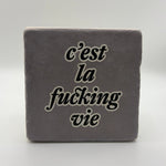 Funny quote 'C'est La Vie' printed on square travertine stone coaster