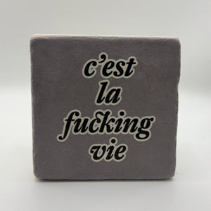 Funny quote 'C'est La Vie' printed on square travertine stone coaster