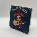Skull artwork inspired by Mexican Dia de Muertos printed on square travertine stone coaster